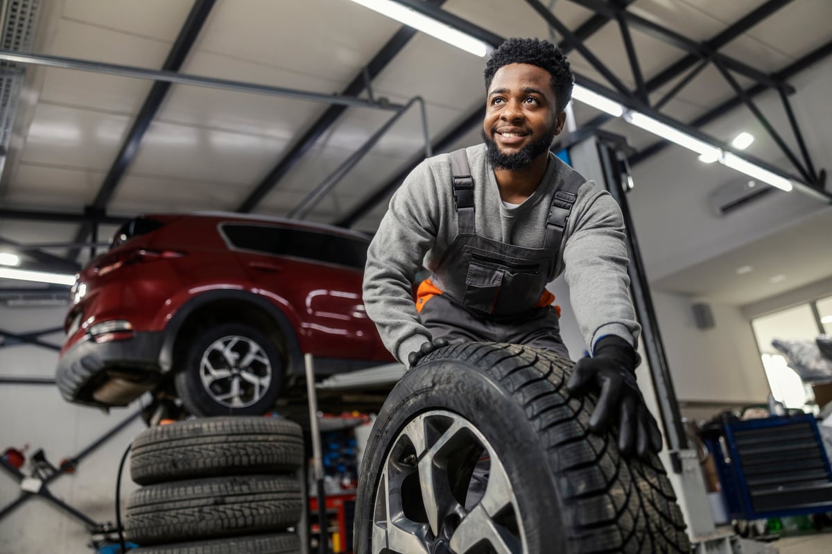 Smiling car technician ready to serve customers